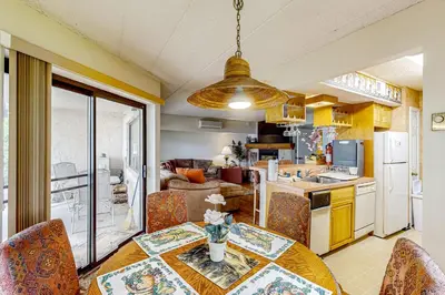 a kitchen and dining room with a table and chairs at Marvel at Midlake in Lake Harmony
