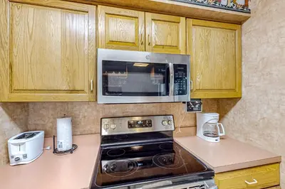 a kitchen with a stove and a microwave at Marvel at Midlake in Lake Harmony