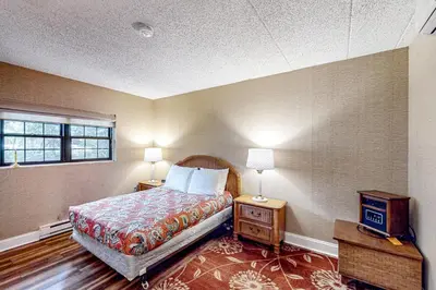 a bedroom with a bed and a window at Marvel at Midlake in Lake Harmony
