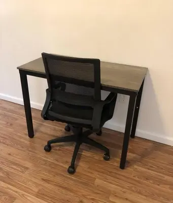 a black desk with a black chair sitting at it at Private apartment with 3 bedrooms and 1 bathroom near Newark International Airport EWR and New York City, MetLife Stadium FIFA World Cup 20 minutes away in Newark