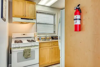 a kitchen with a stove and a fire extinguisher at Cozy Keansburg Cottage Walk to Beach and Boardwalk! in Keansburg