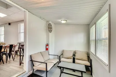 a living room with two chairs and a table at Cozy Keansburg Cottage Walk to Beach and Boardwalk! in Keansburg