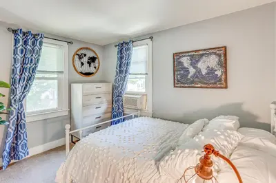 a bedroom with a bed and two windows at 10 Mi to Hersheypark Updated Family Retreat! in Annville