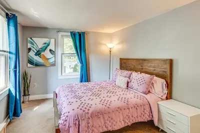 a bedroom with a pink bed and a window at 10 Mi to Hersheypark Updated Family Retreat! in Annville