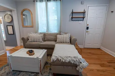 a living room with a couch and a coffee table at Historic Family 3BR Trinity in the Heart of Philly in Philadelphia