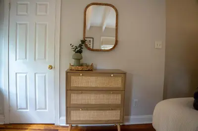 a bedroom with a dresser and a mirror on the wall at Historic Family 3BR Trinity in the Heart of Philly in Philadelphia