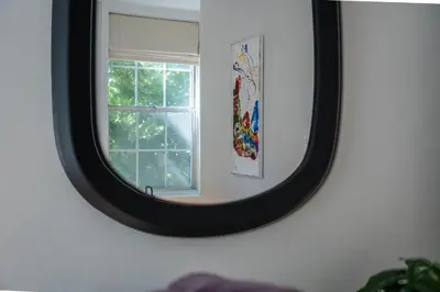 a mirror in a room with a window at Historic Family 3BR Trinity in the Heart of Philly in Philadelphia
