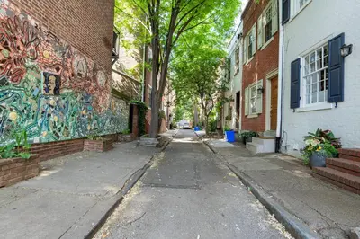 an alley with graffiti on the side of a building at Historic Family 3BR Trinity in the Heart of Philly in Philadelphia