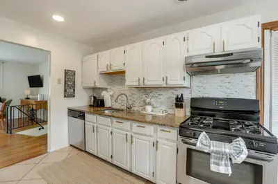 a kitchen with white cabinets and a stove at Somerset Home with Large Yard Near Parks and Trails in Somerset