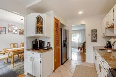 a kitchen with white cabinets and a dining room at Somerset Home with Large Yard Near Parks and Trails in Somerset