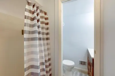 a bathroom with a toilet and a shower curtain at Somerset Home with Large Yard Near Parks and Trails in Somerset