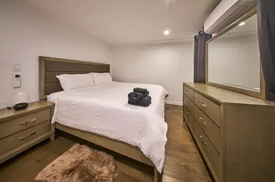 a bedroom with a bed with a bag on it at Modern 2 Bedroom Retreat in Downtown Manhattan in New York