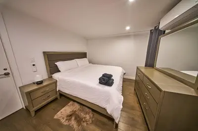 a small bedroom with a bed with a camera on it at Modern 2 Bedroom Retreat in Downtown Manhattan in New York