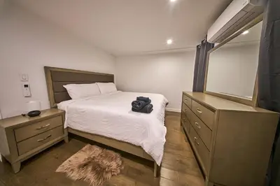 a bedroom with a bed with a camera on it at Modern 2 Bedroom Retreat in Downtown Manhattan in New York