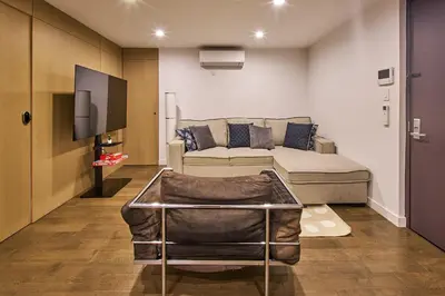 a living room with a couch and a tv at Modern 2 Bedroom Retreat in Downtown Manhattan in New York
