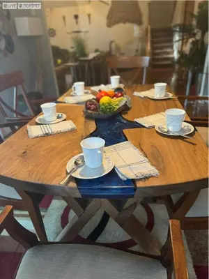 a wooden table with a bowl of fruit and coffee cups at Charming, Restful Getaway in Bushkill