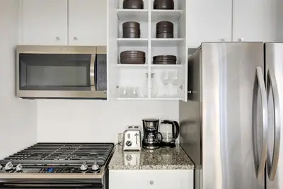 a kitchen with a stove and a refrigerator at UWS 1BR w Elevator Gym nr Central Park NYC-686 in New York