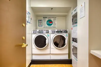 a laundry room with a washer and dryer at UWS 1BR w Elevator Gym nr Central Park NYC-686 in New York