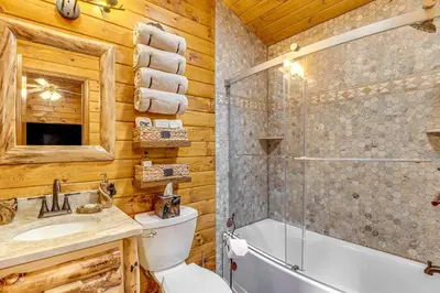 a bathroom with a toilet and a shower and a sink at Game Room and Hot Tub Pine Bear Pocono Lake Cabin in Pocono Lake
