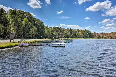a group of boats docked on a lake at Game Room and Hot Tub Pine Bear Pocono Lake Cabin in Pocono Lake