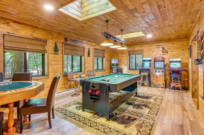 a game room with a pool table and ping pong balls at Game Room and Hot Tub Pine Bear Pocono Lake Cabin in Pocono Lake
