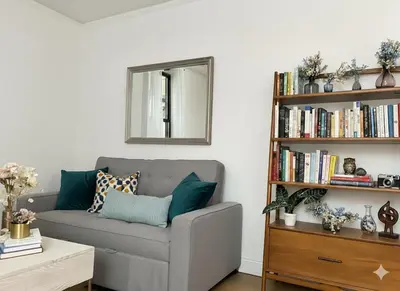 a living room with a couch and a book shelf at Chill In The Village in New York