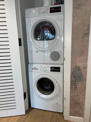 a washing machine and a dryer in a room at Luxury in Little Italy 2 Bedroom Private Balcony in New York