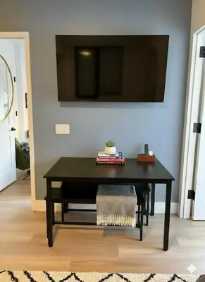 a black table in a room with a tv on a wall at Luxury in Little Italy 2 Bedroom Private Balcony in New York