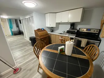 a kitchen with a table with chairs and a stove at Oasis in New Jersey - 2BR NYC Access in West New York