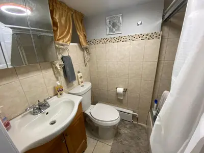 a small bathroom with a toilet and a sink at Oasis in New Jersey - 2BR NYC Access in West New York
