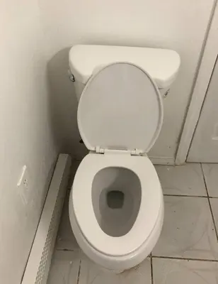 a bathroom with a white toilet in a stall at Private 3 bedroom and 1 bathroom house, direct NYC Manhattan train a 15 minute walk away, MetLife Stadium FIFA World Cup 35 minutes away in Perth Amboy