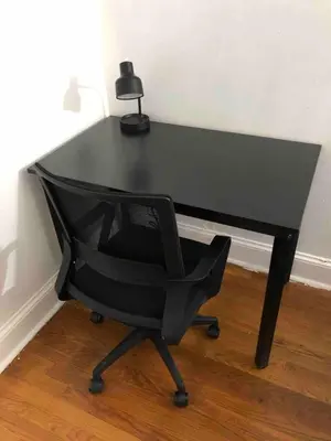 a black desk with a chair and a lamp at Spacious 2-bedroom apartment with 1-bathroom and private street entrance, MetLife Stadium FIFA World Cup 25 minutes away in Paterson
