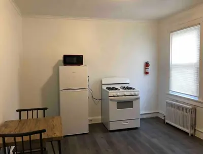 a kitchen with a white stove and a refrigerator at Spacious 2-bedroom apartment with 1-bathroom and private street entrance, MetLife Stadium FIFA World Cup 25 minutes away in Paterson