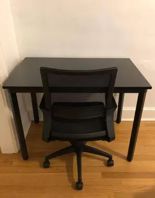 a black desk with a black chair in a room at Spacious 2-bedroom apartment with 1-bathroom and private street entrance, MetLife Stadium FIFA World Cup 25 minutes away in Paterson