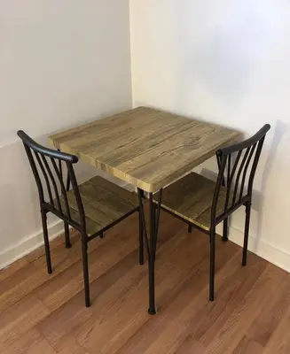 a wooden table and two chairs sitting next to a table at Private apartment with 1 bedroom and 1 bathroom, MetLife Stadium FIFA World Cup 25 minutes away in Paterson