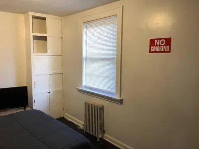 a bedroom with a bed and a no smoking sign on the wall at Private apartment with 1 bedroom and 1 bathroom, MetLife Stadium FIFA World Cup 25 minutes away in Paterson