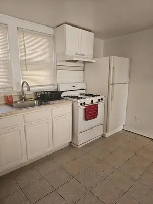 a kitchen with a white stove and a refrigerator at Private apartment with 1 bedroom and 1 bathroom, MetLife Stadium FIFA World Cup 25 minutes away in Paterson
