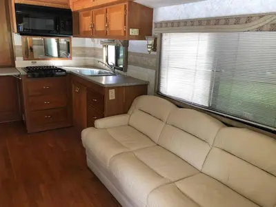 a living room with a couch in a caravan at Private 1-bedroom RV, direct bus to NYC Manhattan only 2 blocks away, MetLife Stadium FIFA World Cup 25 minutes away in Linden