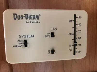 a temperature board on a wall with a thermometer at Private 1-bedroom RV, direct bus to NYC Manhattan only 2 blocks away, MetLife Stadium FIFA World Cup 25 minutes away in Linden