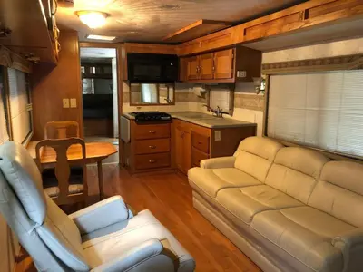 a living room with a couch and a kitchen at Private 1-bedroom RV, direct bus to NYC Manhattan only 2 blocks away, MetLife Stadium FIFA World Cup 25 minutes away in Linden