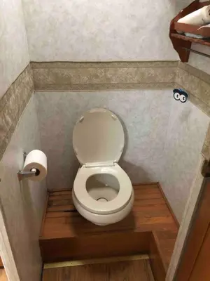 a small bathroom with a toilet in a stall at Private 1-bedroom RV, direct bus to NYC Manhattan only 2 blocks away, MetLife Stadium FIFA World Cup 25 minutes away in Linden