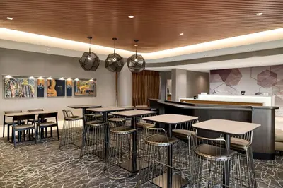 a restaurant with tables and chairs and a bar at SpringHill Suites by Marriott Easton PA in Easton