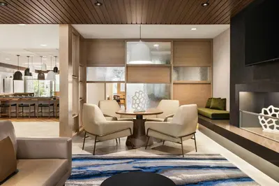 a living room with a table and chairs at Fairfield by Marriott Inn & Suites Bethlehem PA in Bethlehem