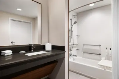 a bathroom with a sink and a tub and a mirror at Fairfield by Marriott Inn & Suites Bethlehem PA in Bethlehem