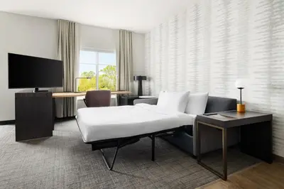 a hotel room with a large bed and a desk at Residence Inn by Marriott King of Prussia in King of Prussia
