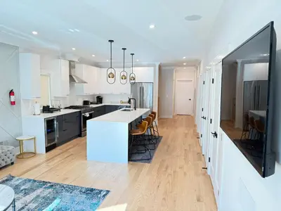 a kitchen with white cabinets and a white counter top at Huge 2000 sqft Luxury & Stylish Condo minutes to New York in Jersey City
