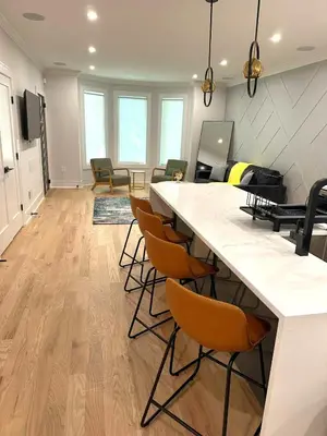a large living room with a large counter and chairs at Huge 2000 sqft Luxury & Stylish Condo minutes to New York in Jersey City