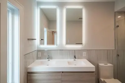 a bathroom with a sink and a mirror and a toilet at Huge 2000 sqft Luxury & Stylish Condo minutes to New York in Jersey City