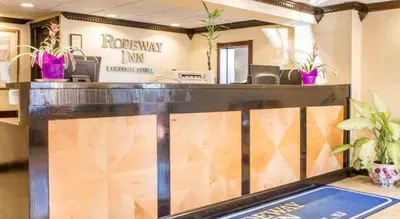 a lobby with a reception desk with potted plants at Rodeway Inn Mount Laurel Hwy 73 in Ramblewood