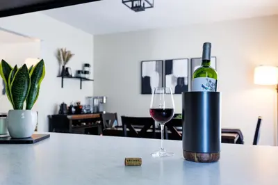 a bottle of wine and a glass on a table at The Cooper Home, Dogs Welcome! in Ephrata